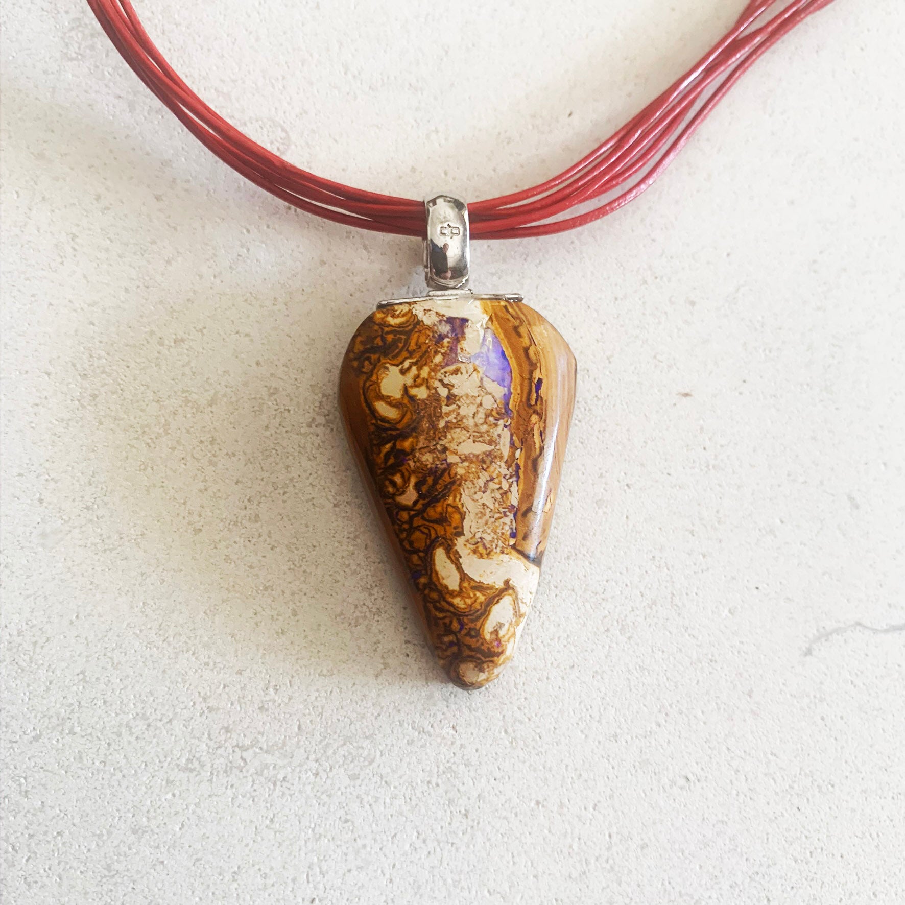 Boulder opal pendant on leather strand necklet