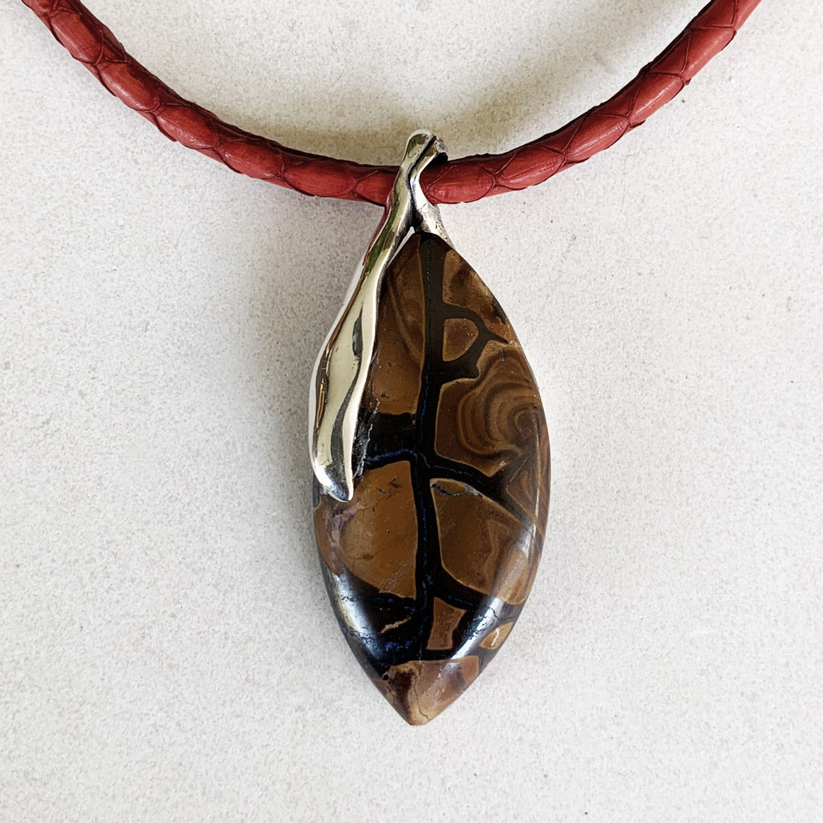 Boulder opal pendant on red leather necklet